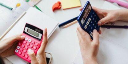 Two students with calculators at a table representing scaffolded math activities.